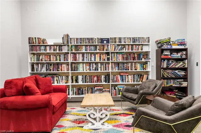 a living room with furniture and a book shelf