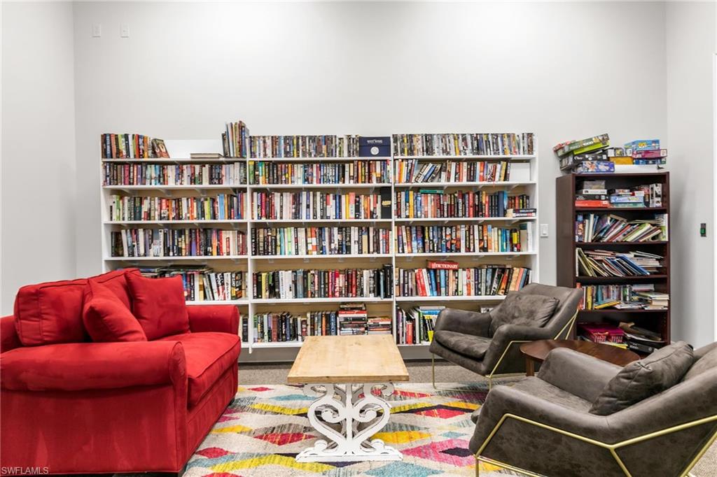 1473 Birdie Drive Naples, FL 34120 - Photo 45 of 50 a living room with furniture and a book shelf