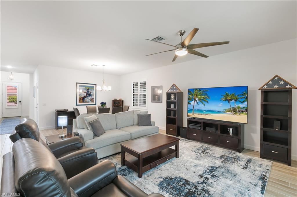 1473 Birdie Drive Naples, FL 34120 - Photo 8 of 50 a living room with furniture and a flat screen tv