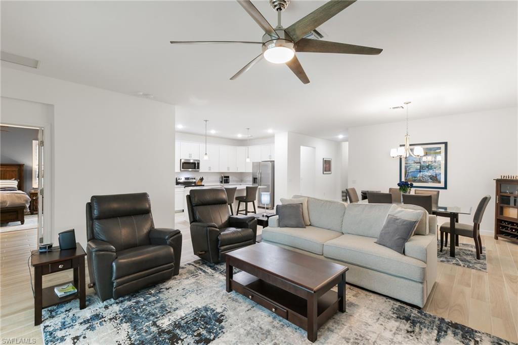 1473 Birdie Drive Naples, FL 34120 - Photo 9 of 50 a living room with furniture and a view of kitchen