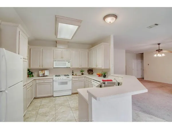 a kitchen that has a sink and a stove in it