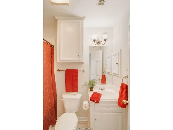 a bathroom with a sink toilet and mirror
