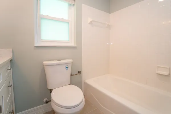 a bathroom with a toilet a sink a vanity and mirror
