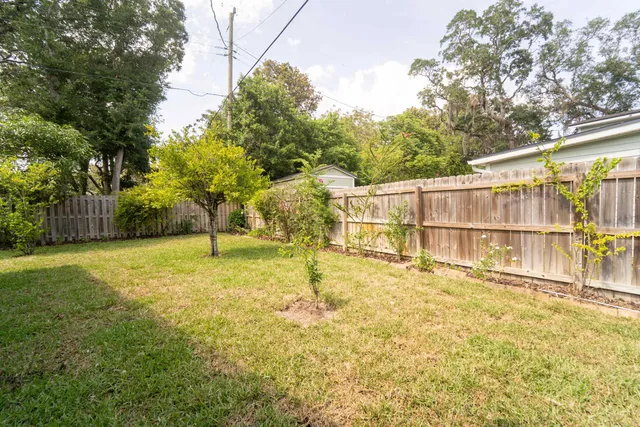 an aerial view of house with yard and mountain view in back