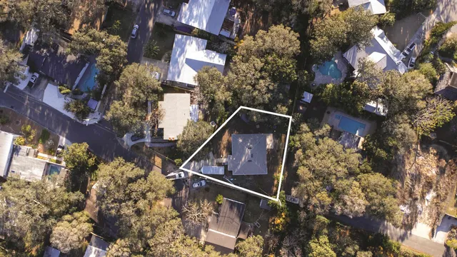an aerial view of a house with a garden and a yard