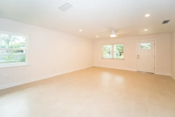 an empty room with windows and entrance