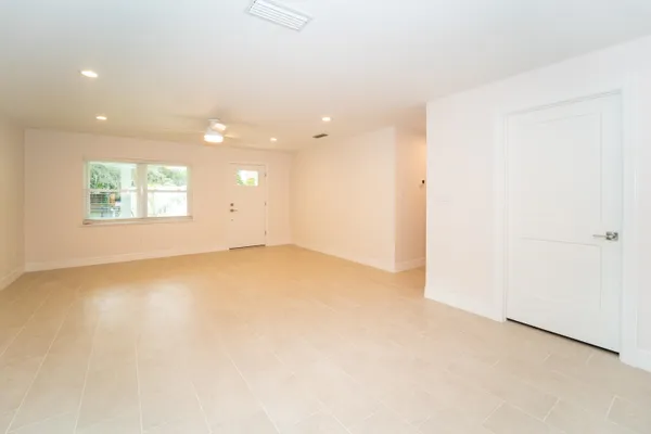 an empty room with a empty space and windows