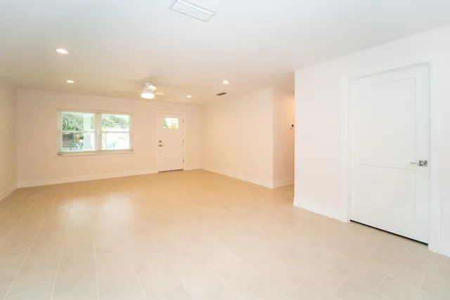 an empty room with a empty space and windows