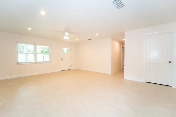a view of a kitchen with a sink and a refrigerator