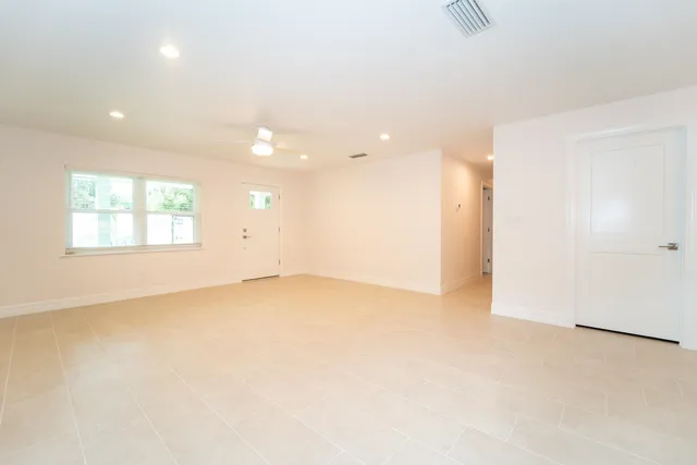 a view of a kitchen with a sink and a refrigerator