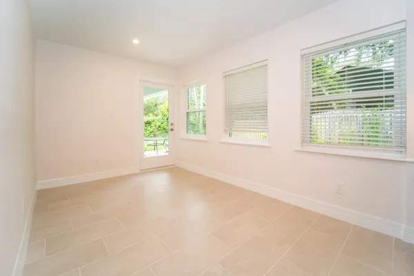 a kitchen with kitchen island granite countertop a sink cabinets and wooden floor