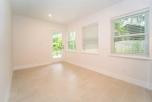 a kitchen with kitchen island granite countertop a sink cabinets and wooden floor