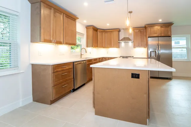 a kitchen that has a sink a window and a counter top space