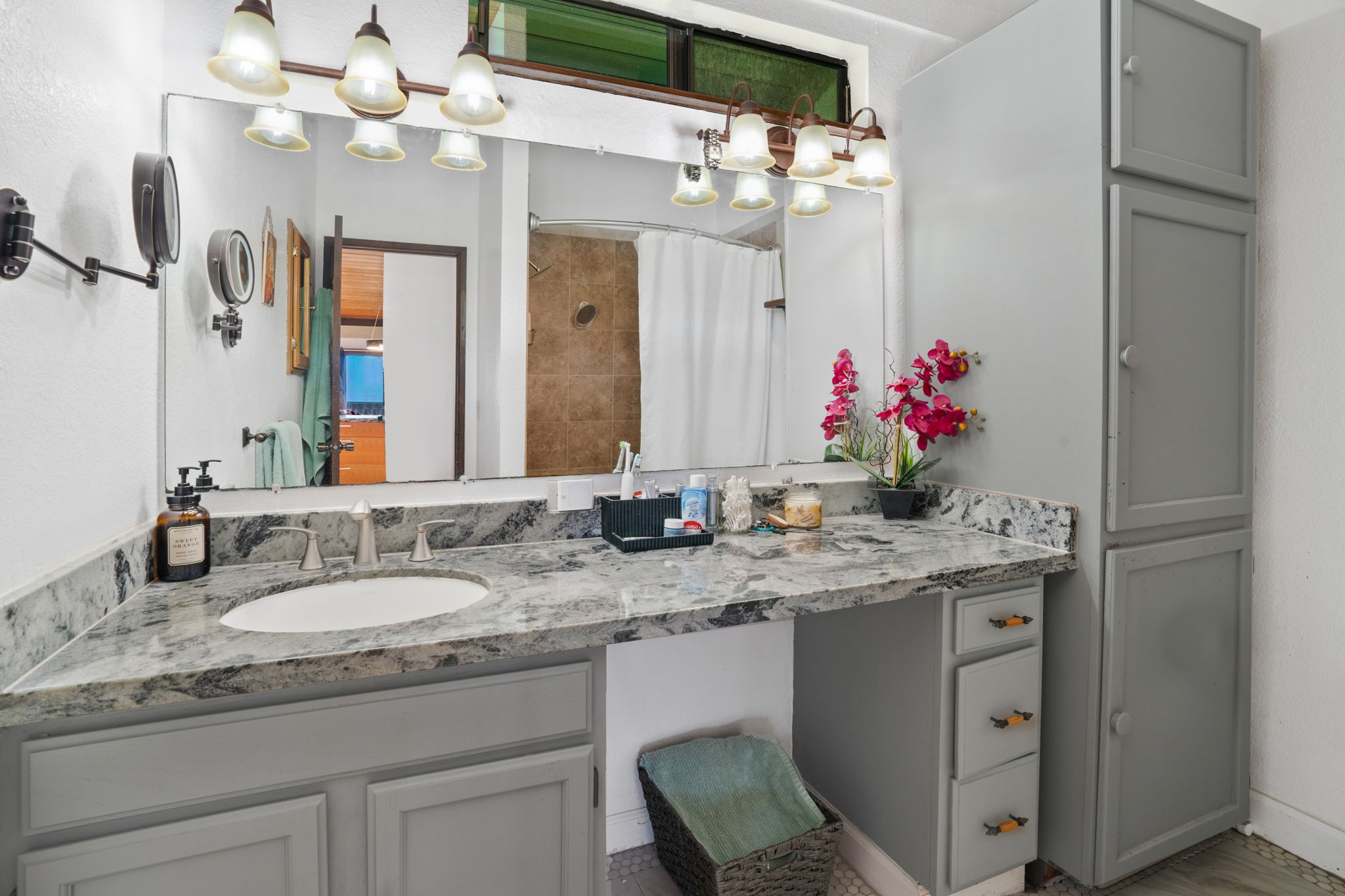 3748 Kikee Road Kalaheo, HI 96741 - Photo 15 of 27 a bathroom with a granite countertop sink a large mirror and a refrigerator