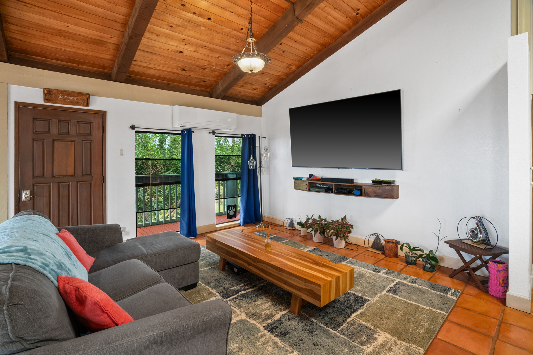 3748 Kikee Road Kalaheo, HI 96741 - Photo 17 of 27 a living room with furniture a flat screen tv and a large window