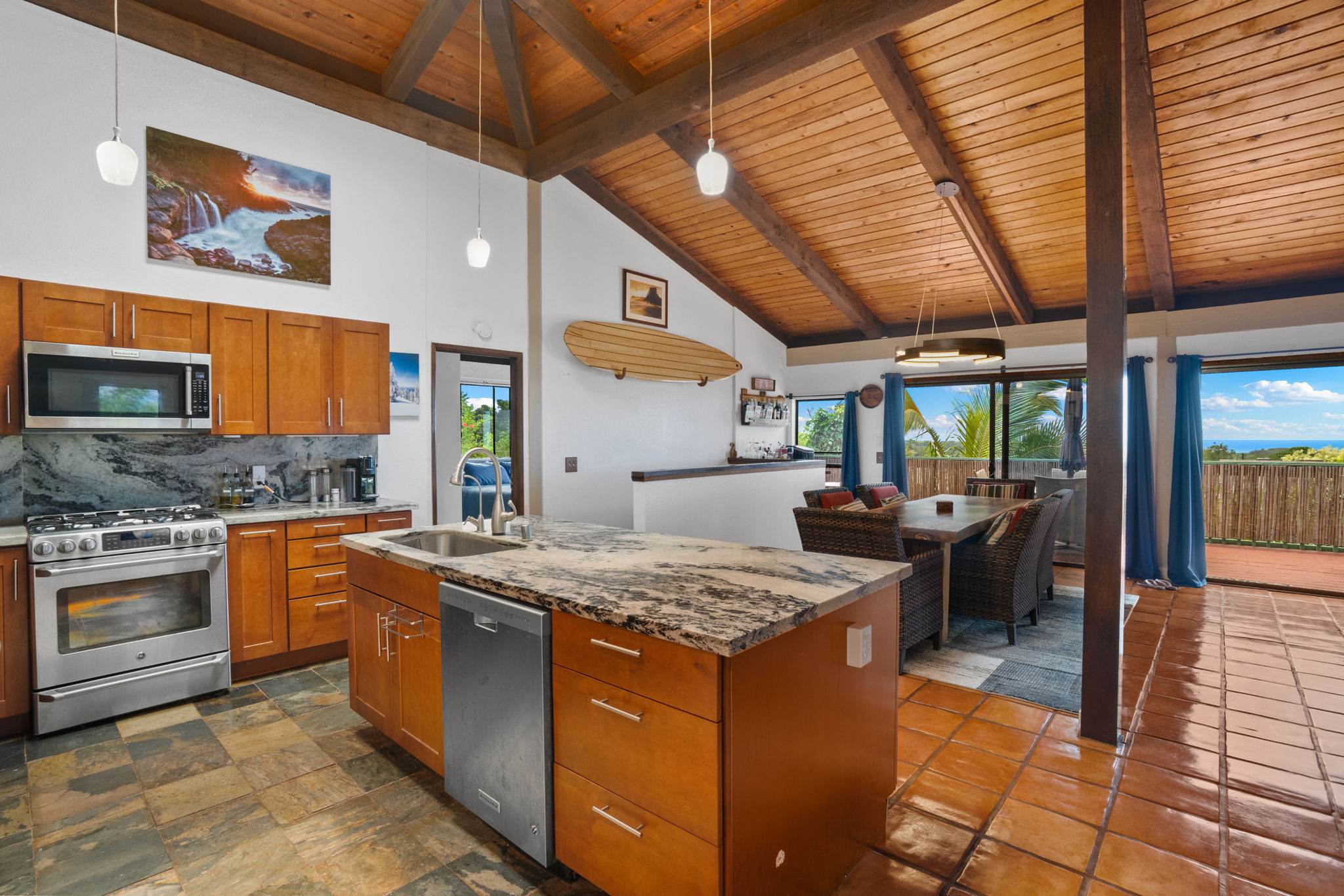 3748 Kikee Road Kalaheo, HI 96741 - Photo 4 of 27 a kitchen with stainless steel appliances granite countertop a stove a sink and a microwave