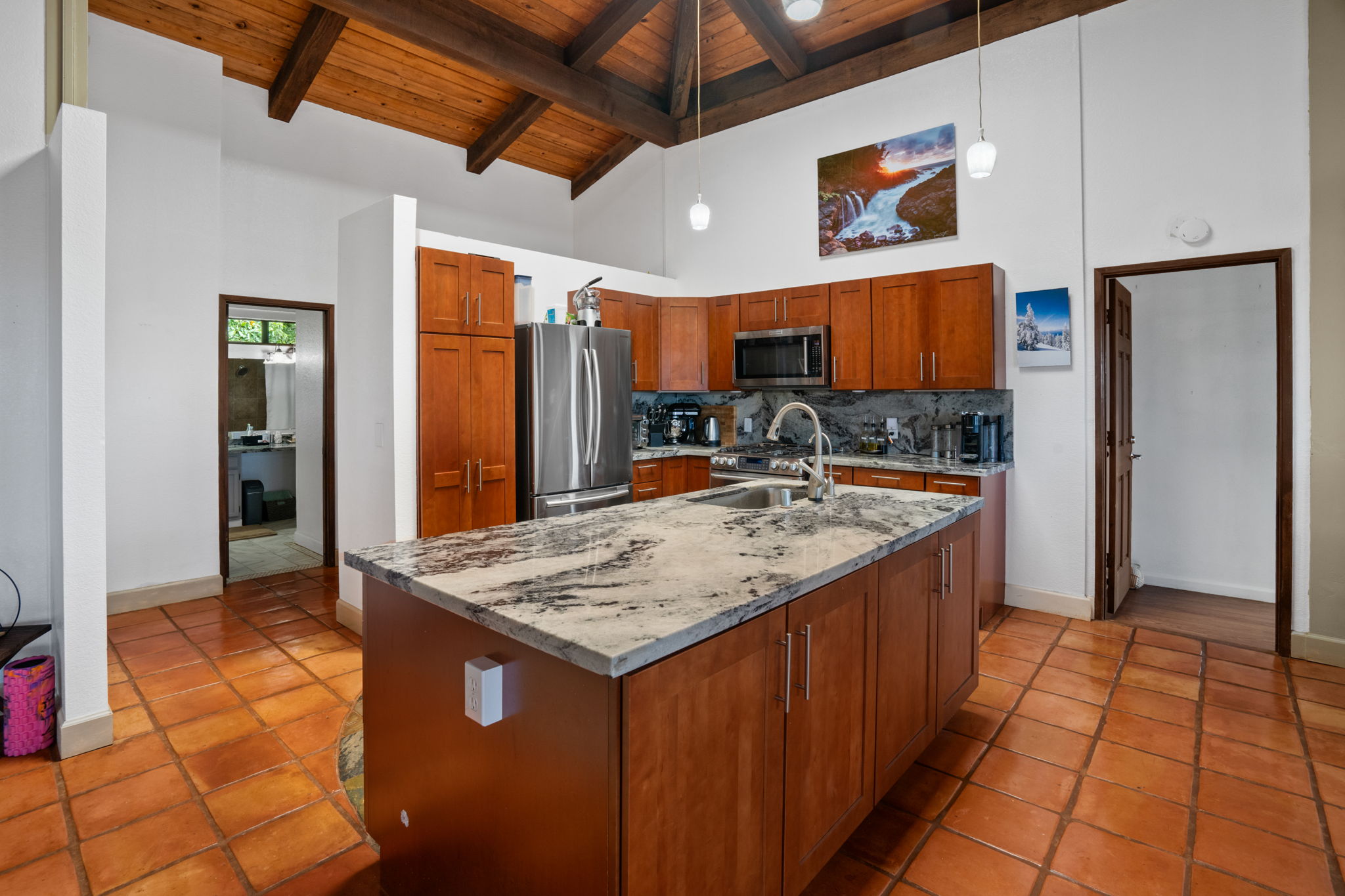 3748 Kikee Road Kalaheo, HI 96741 - Photo 6 of 27 a kitchen with kitchen island granite countertop a sink and refrigerator