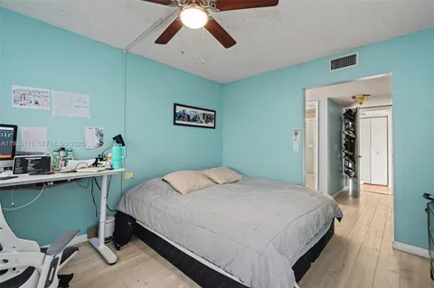 a bedroom with a bed and a desk