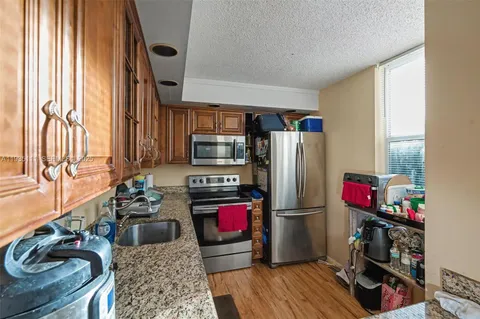 a kitchen with stainless steel appliances a refrigerator and a stove top oven