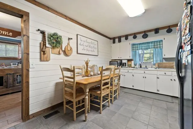 a white kitchen with a sink and cabinets