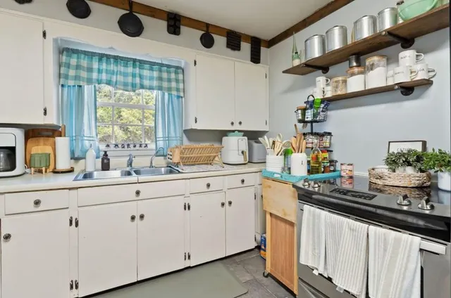 a kitchen with cabinets and window