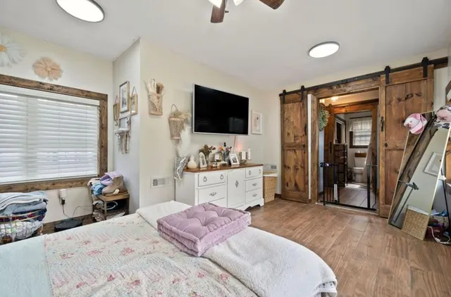 a bed room with a bed and a television