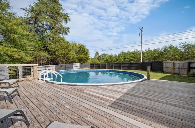 a view of a swimming pool with a yard