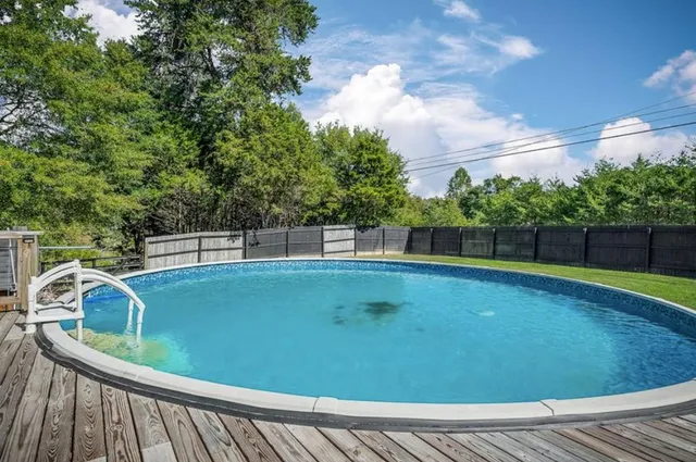 a view of a swimming pool with a patio