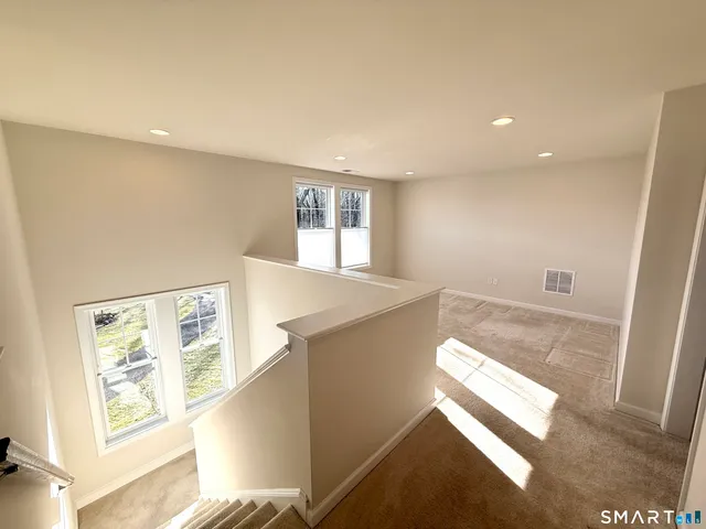 a black and white photo of a book and a bed