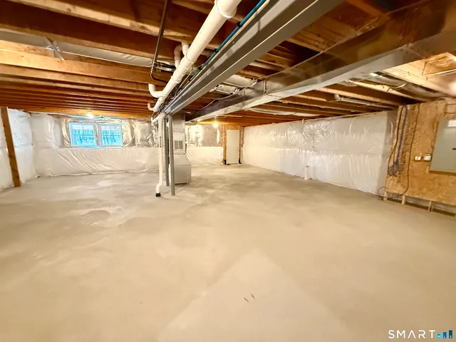 a kitchen with stainless steel appliances granite countertop a stove and a white cabinets
