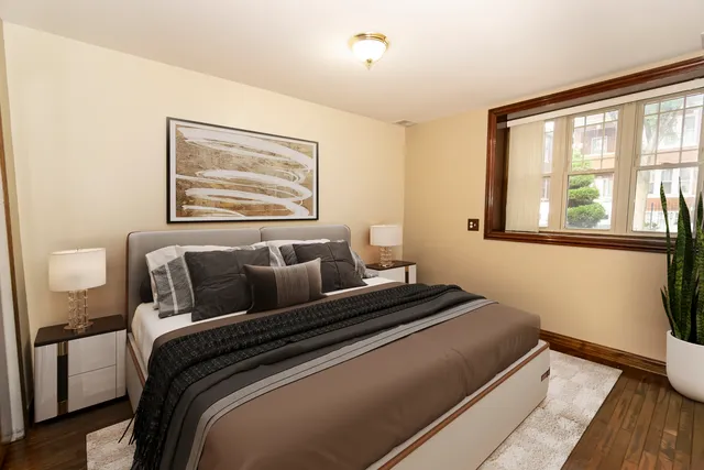 a bedroom with a bed and wooden floor