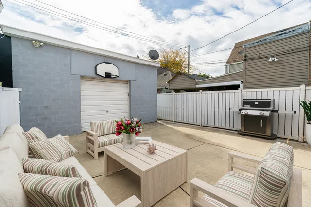 a balcony with furniture and a potted plant