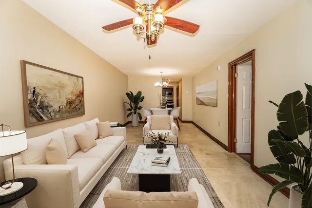 a living room with furniture and a chandelier