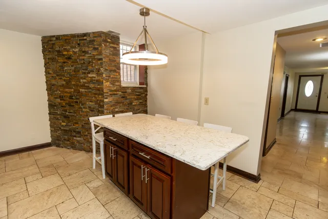 a kitchen with a sink a counter space and a refrigerator