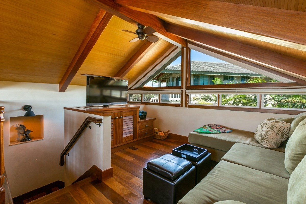 1871 Pe'e Road, Unit 1 Koloa, HI 96756 - Photo 17 of 24 a living room with furniture and a floor to ceiling window
