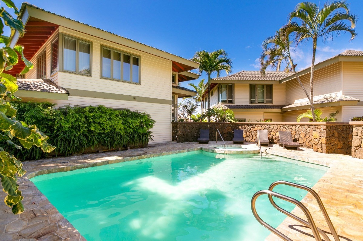 1871 Pe'e Road, Unit 1 Koloa, HI 96756 - Photo 20 of 24 a backyard of a house with table and chairs plants and wooden fence