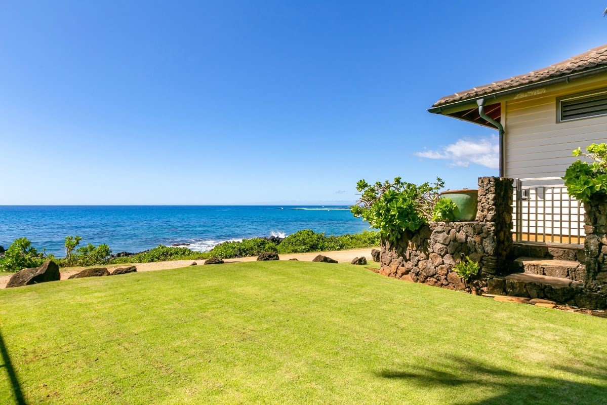 1871 Pe'e Road, Unit 1 Koloa, HI 96756 - Photo 22 of 24 a view of an ocean with a house in the background