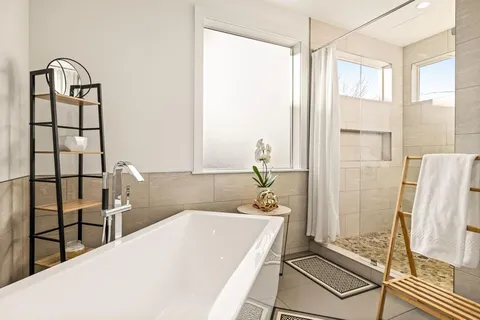 a view of a house with backyard and sitting area