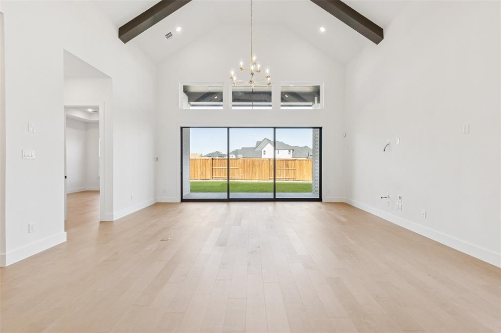 4050 Gambel Road Prosper, TX 75078 - Photo 10 of 23 Indoor-outdoor entertaining is a breeze in this elegant family room featuring a full wall slider that opens to a spacious covered back patio!