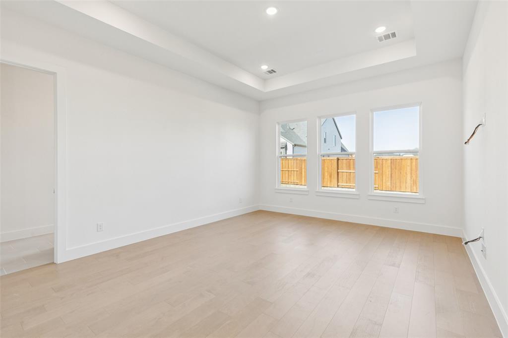 4050 Gambel Road Prosper, TX 75078 - Photo 12 of 23 This dreamy owners suite combines high ceilings and oversized windows to create a relaxing and peaceful retreat.