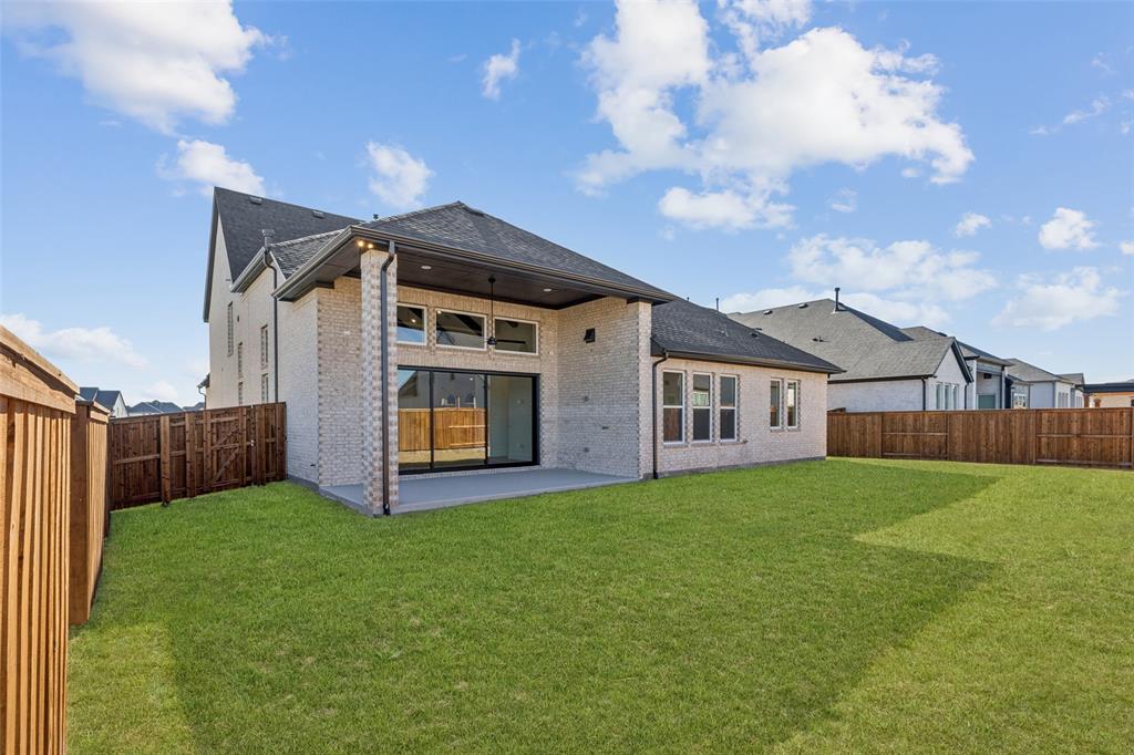 4050 Gambel Road Prosper, TX 75078 - Photo 17 of 23 Outdoor family fun time awaits you in this private, fenced back yard with spacious covered back patio.