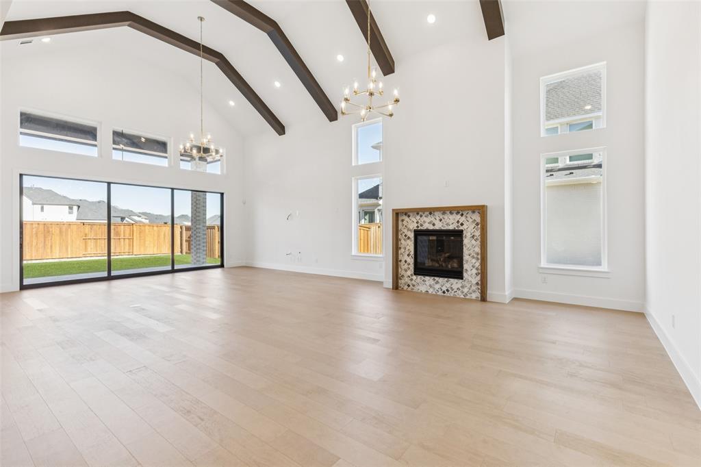 4050 Gambel Road Prosper, TX 75078 - Photo 6 of 23 Featuring an elegant fireplace and beamed ceiling, you'll enjoy sophisticated dinner parties in this dream dining room!