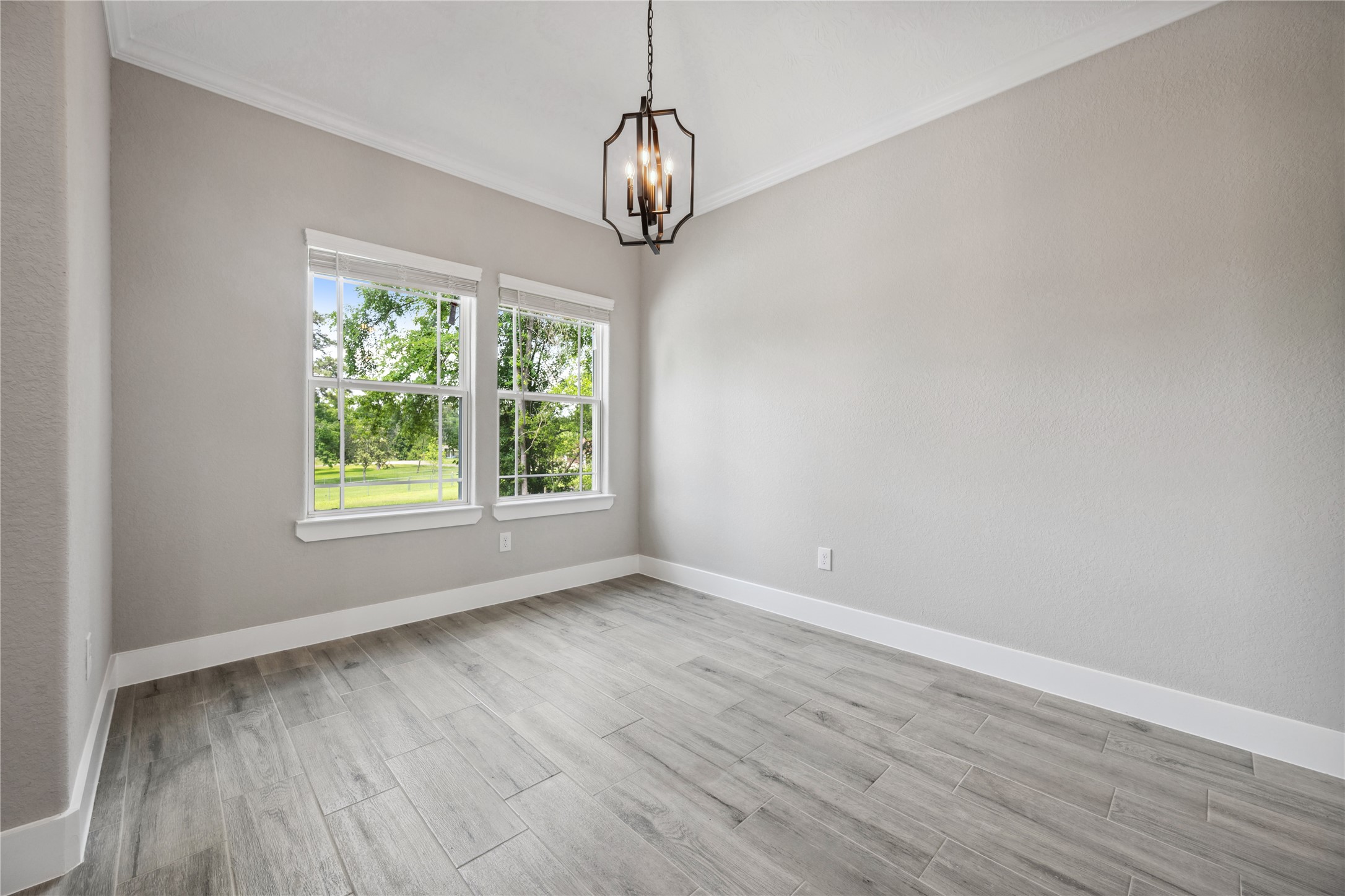 139 Popular Street Onalaska, TX 77360 - Photo 5 of 27 Dining room with high ceilings, crown molding and large windows.