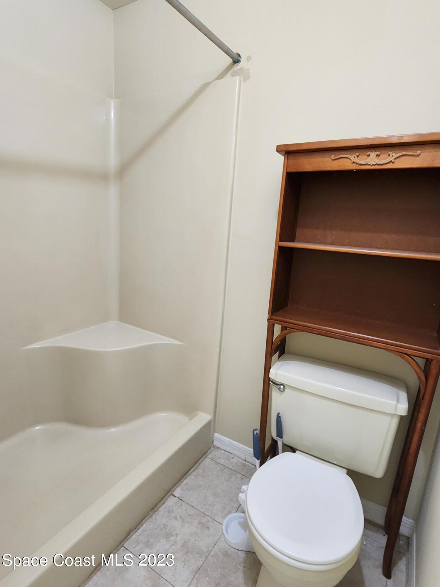 2939 Regency Drive Melbourne, FL 32935 - Photo 11 of 39 a bathroom with a toilet and a bathtub