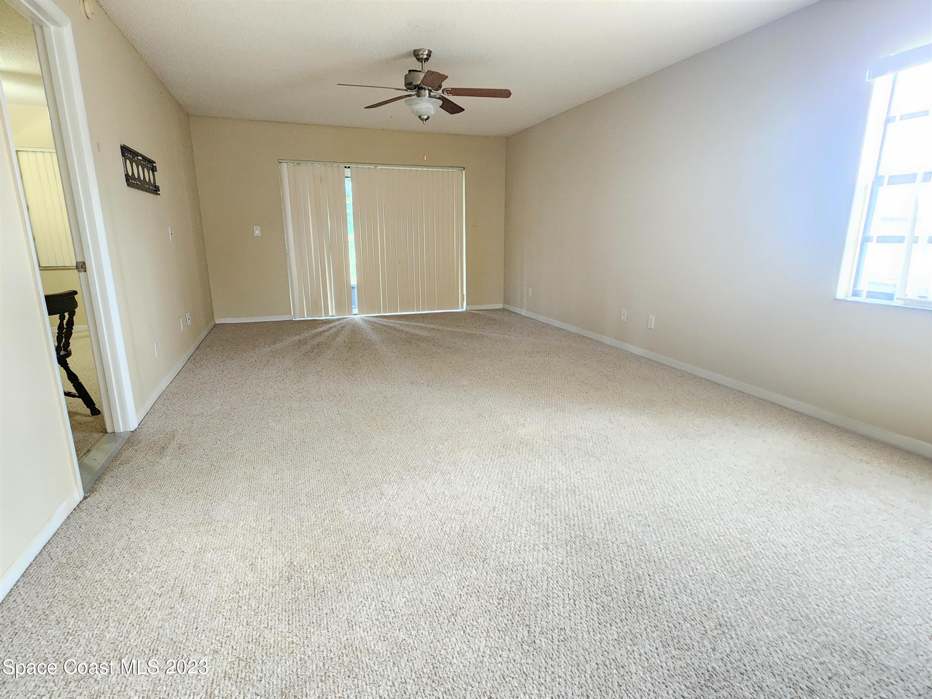2939 Regency Drive Melbourne, FL 32935 - Photo 12 of 39 an empty room with windows and cabinet