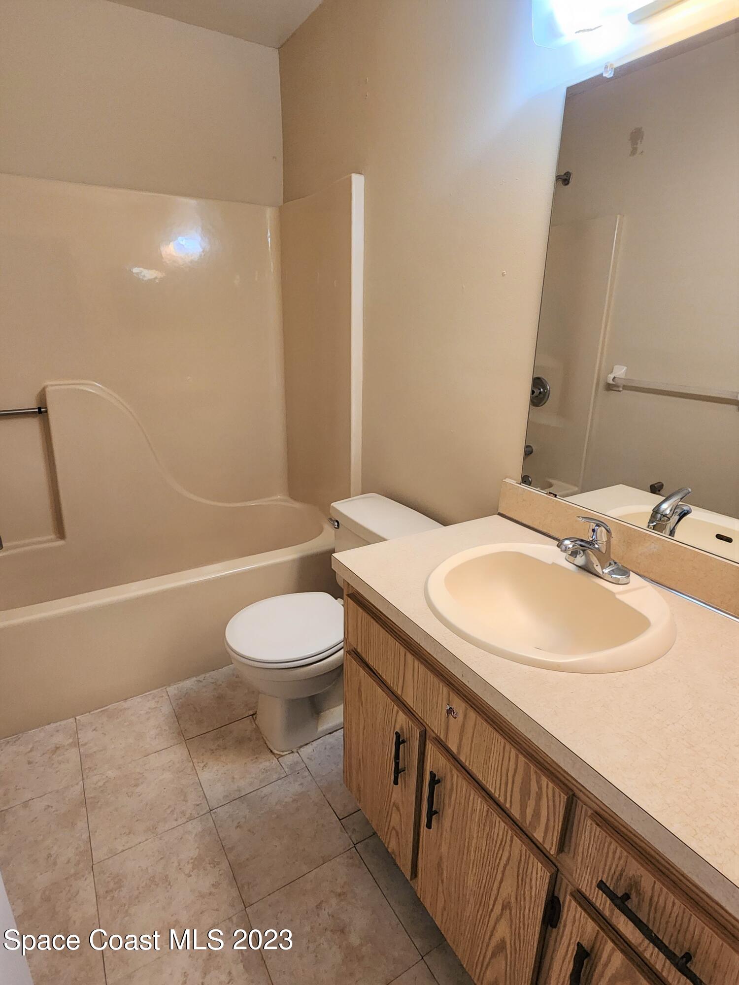 2939 Regency Drive Melbourne, FL 32935 - Photo 14 of 39 a bathroom with a sink a toilet and shower