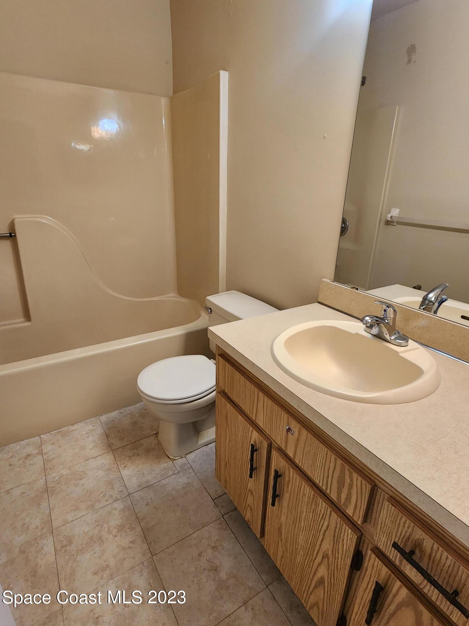 2939 Regency Drive Melbourne, FL 32935 - Photo 15 of 39 a bathroom with a sink a toilet and shower