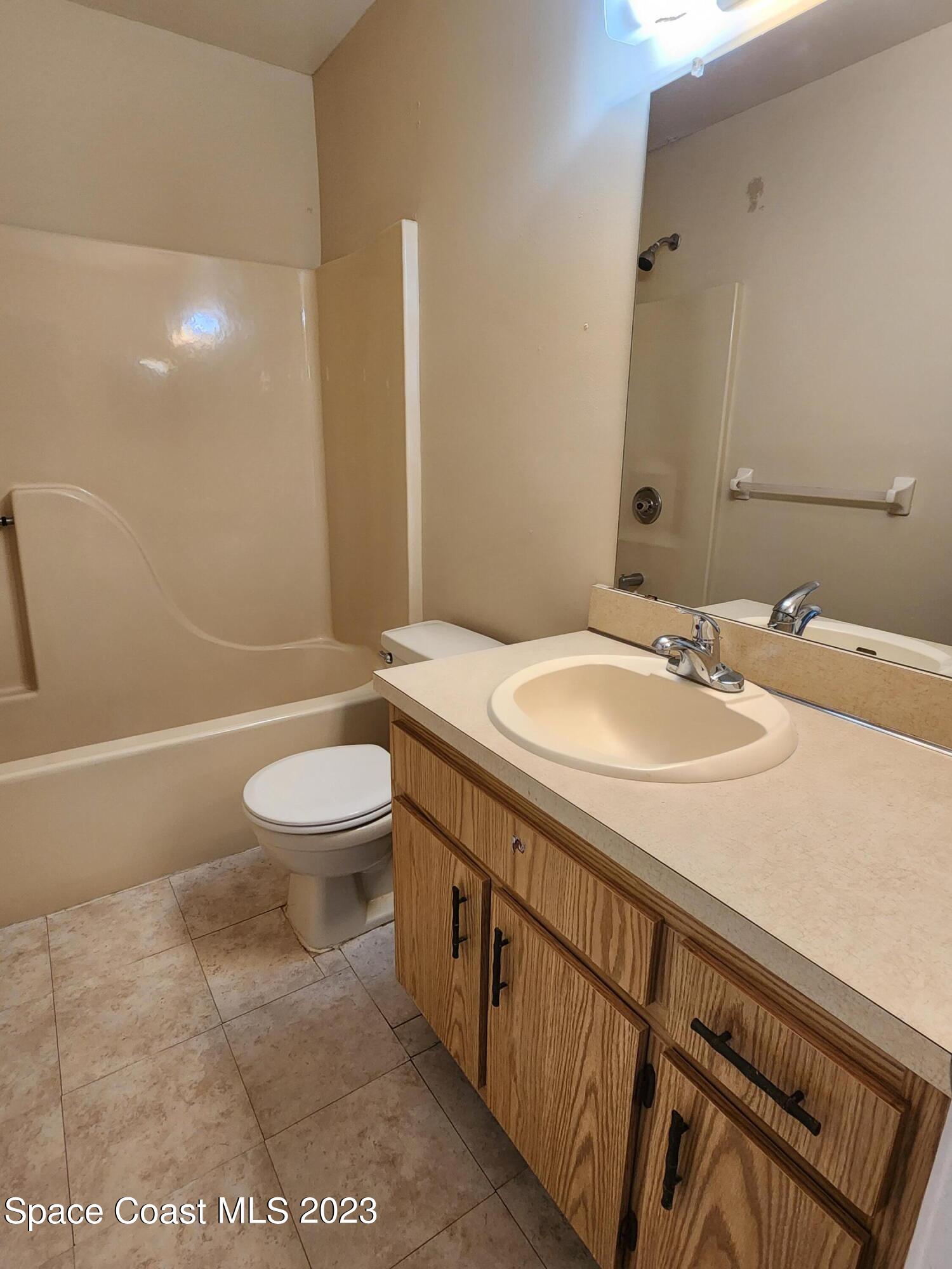 2939 Regency Drive Melbourne, FL 32935 - Photo 16 of 39 a bathroom with a sink a toilet and shower