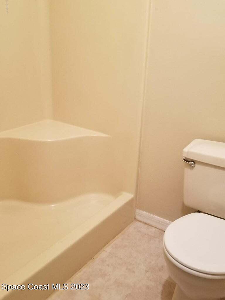 2939 Regency Drive Melbourne, FL 32935 - Photo 23 of 39 a bathroom with a toilet and a bathtub