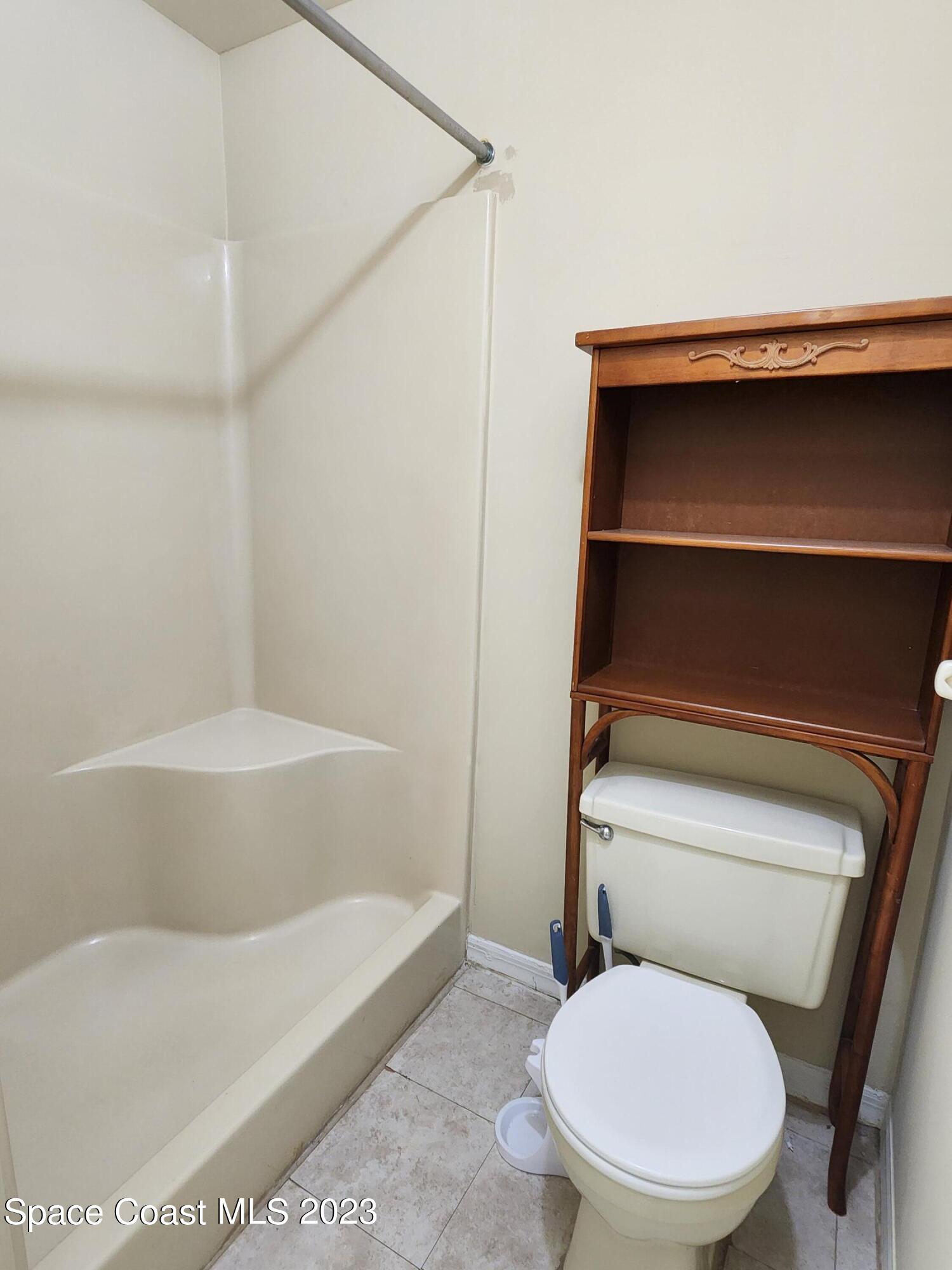 2939 Regency Drive Melbourne, FL 32935 - Photo 10 of 39 a bathroom with a toilet and a bathtub
